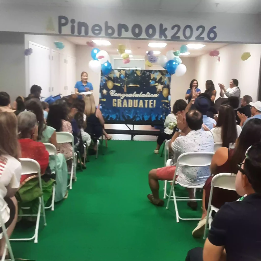 Parents seated watching Pinebrook 2026 pre-K graduation ceremony
