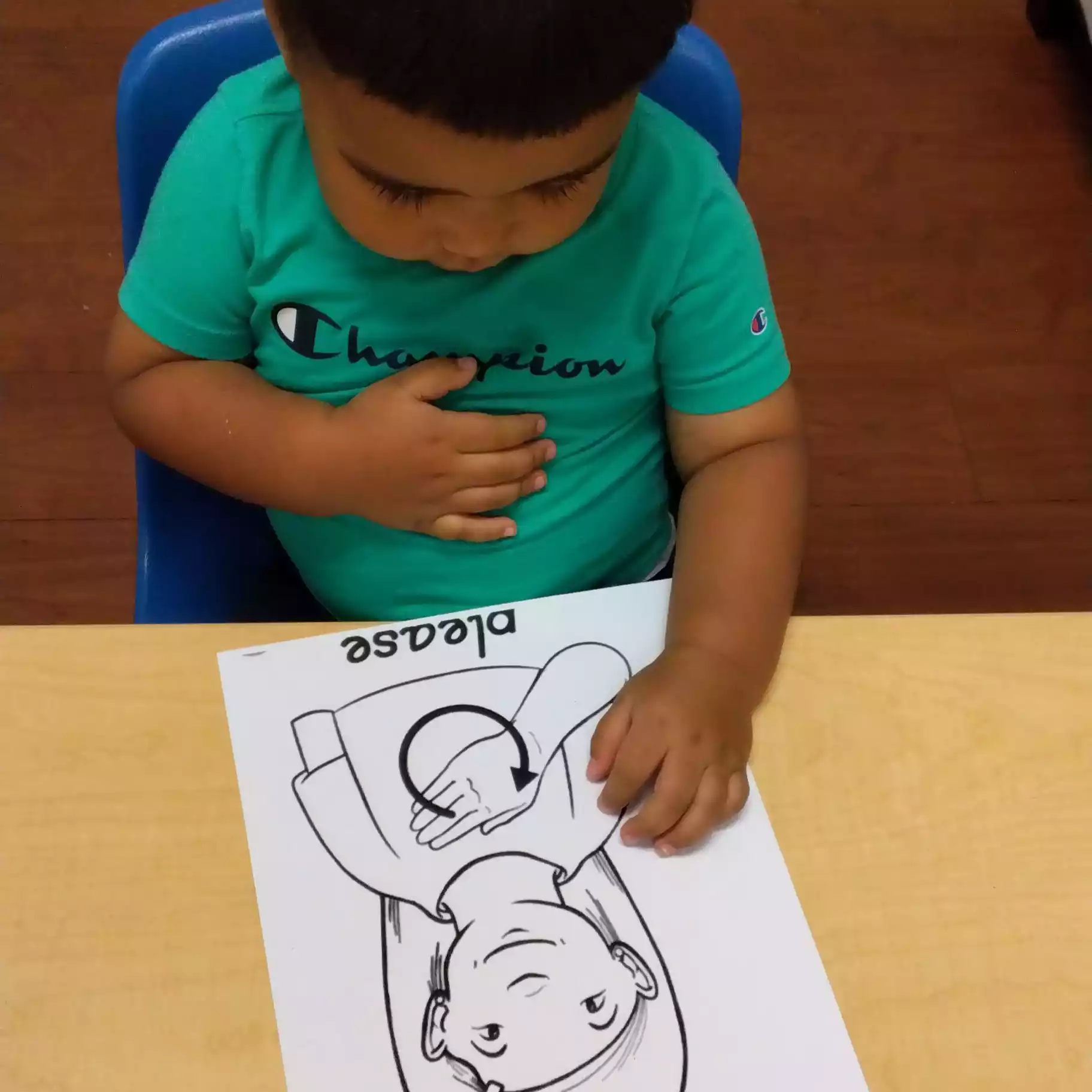 Pinebrook Pre-K Student Practicing Sign Language Activity Student looking at sign language worksheet at Pinebrook Montessori